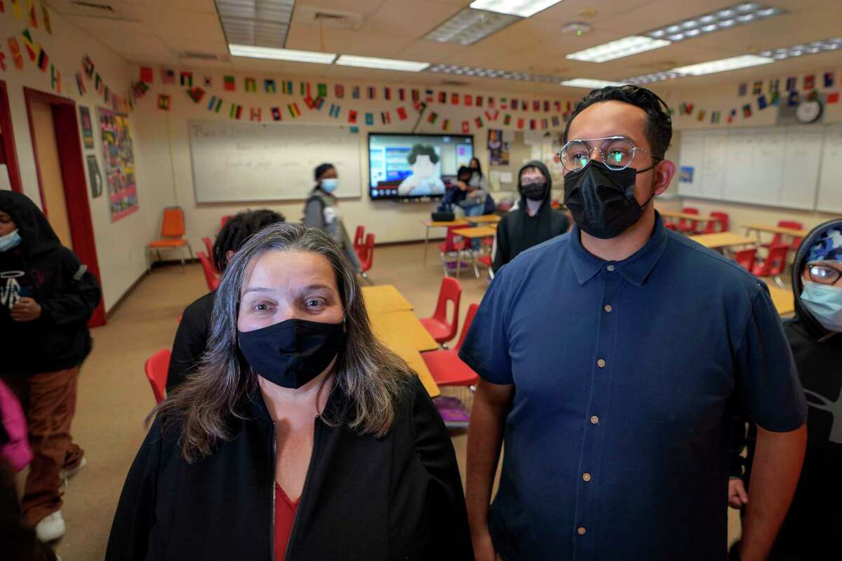 Mojave Unified School District Superintendent Katherine Aguirre, left, and Benito Luna, a 7th-grade social studies teacher, meet with his students at California City Middle School in California City, Calif., on Friday, March 11, 2022. Since the pandemic started, experts have warned of a mental health crisis facing American children that is now visibly playing out at schools across the country.