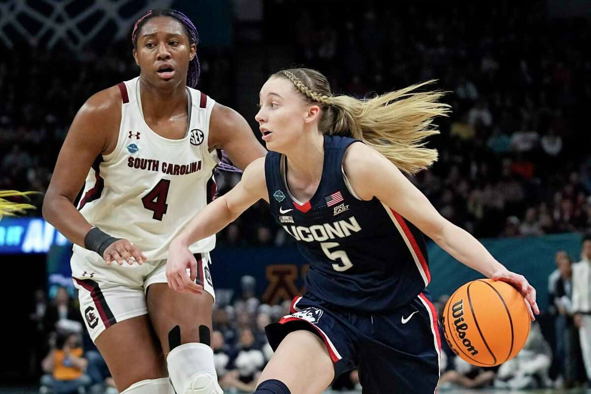 UConn's Paige Bookers is looking to defeat South Carolina's Aaliyah Boston in the first half of a college basketball game in the final round of the Women's Final Four NCAA Tournament in Minneapolis on April 3, 2022.  (AP Photo/Eric Gay)