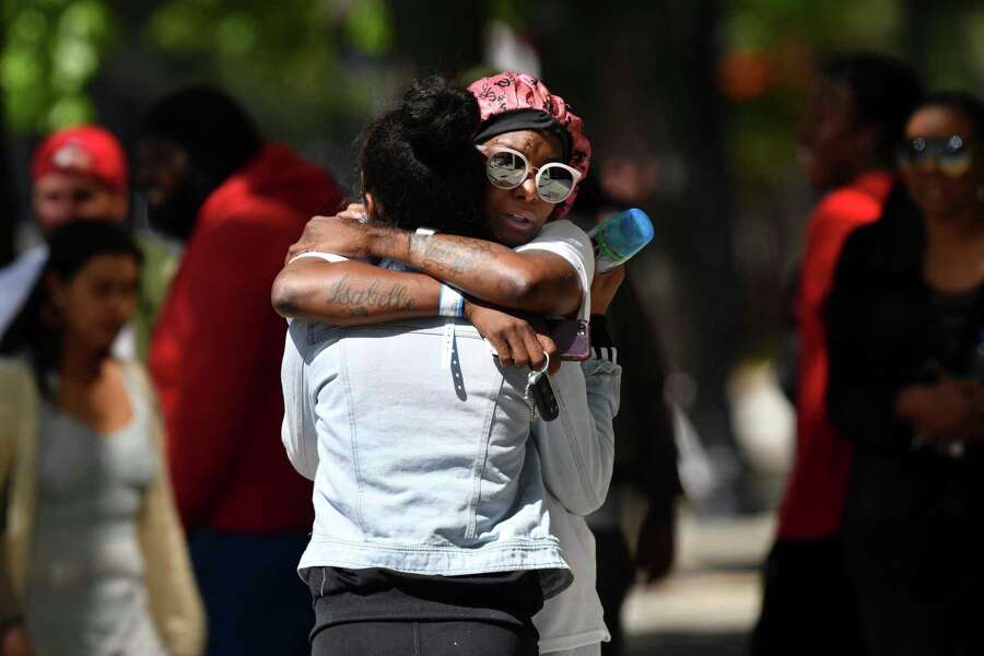 Two women hug each other at the scene of a mass shooting in Sacramento, Calif., on Sunday, April 3, 2022. (Jose Carlos Fajardo/Bay Area News Group via AP)