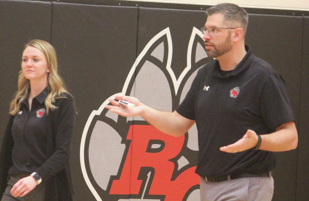 Reed City coach Tim Beilfuss (right) and assistant Emma Lockhart get read for a Coyote game during the season.