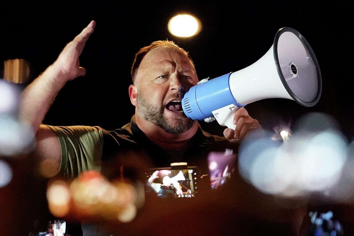 “Infowars” host and conspiracy theorist Alex Jones rallies pro-Trump supporters outside the Maricopa County Recorder’s Office, Nov. 5, 2020, in Phoenix.