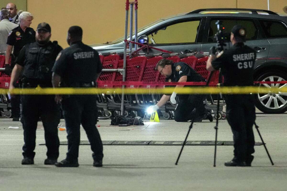 Law enforcement officers investigate the scene of an officer-involved shooting in the parking lot of a grocer store at 2929 FM 1960 near Aldine Westfield Thursday, March 31, 2022 in Houston. Crime is a central focus of Republican messaging for this year’s elections, including the Harris County judge’s race.