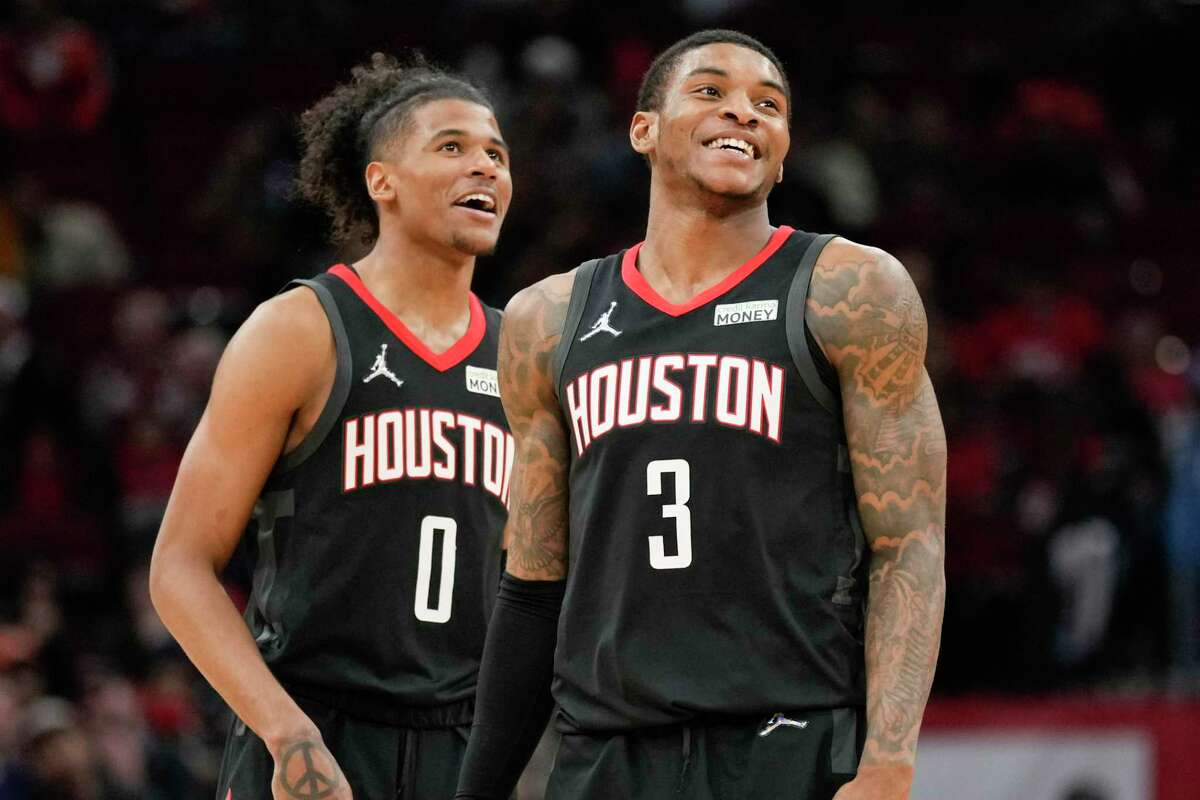 Houston Rockets guards Kevin Porter Jr. (3) and Jalen Green (0) smile late in the second half of an NBA basketball game against the Washington Wizards, Monday, March 21, 2022, in Houston. (AP Photo/Eric Christian Smith)