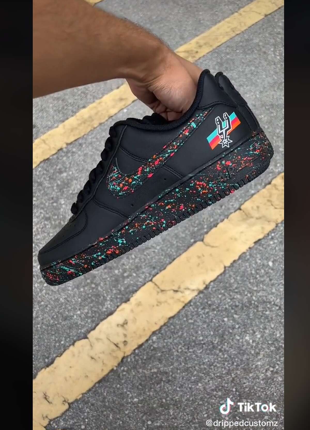 A screenshot of a TikTok video showing how a user customized Nike shoes into a San Antonio Spurs-inspired shoe with Fiesta colors.