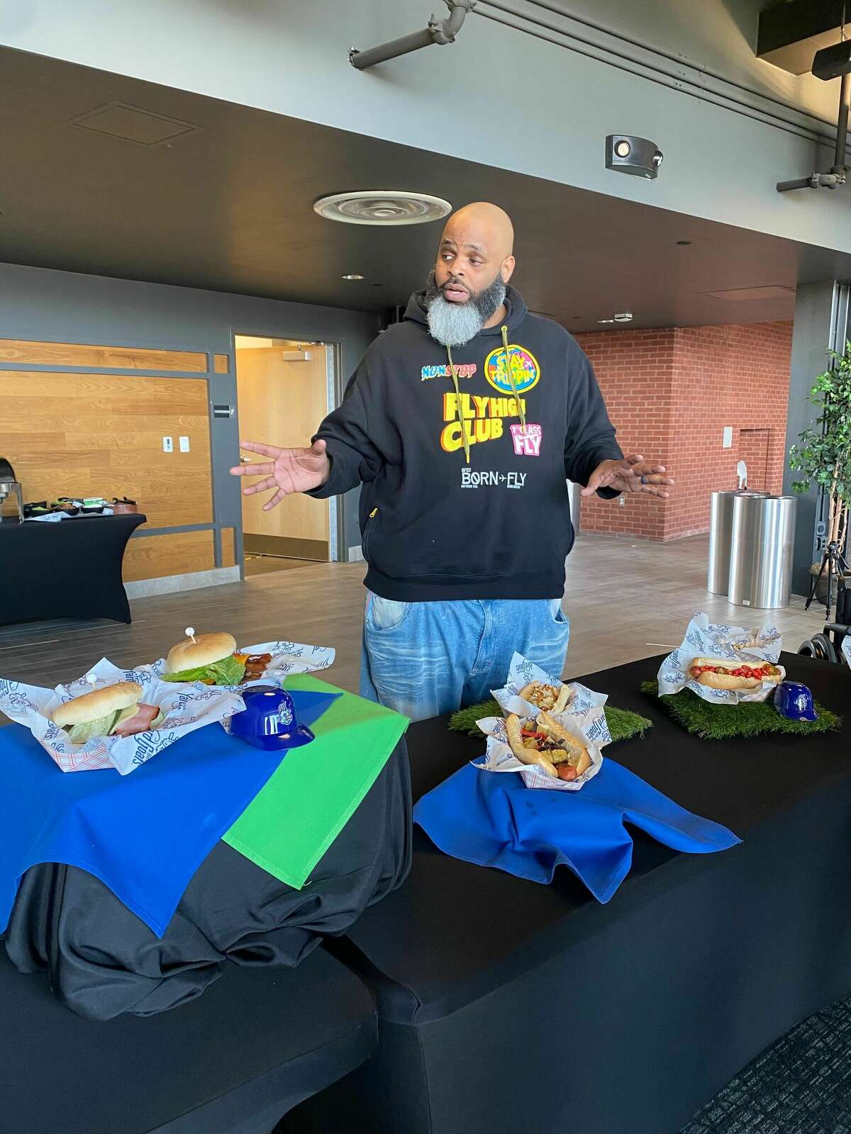 Daymon "Daym Drops" Patterson introduces the new foods at his branded concession stand at Dunkin' Donuts Park, including specialty hot dogs and street corn. 