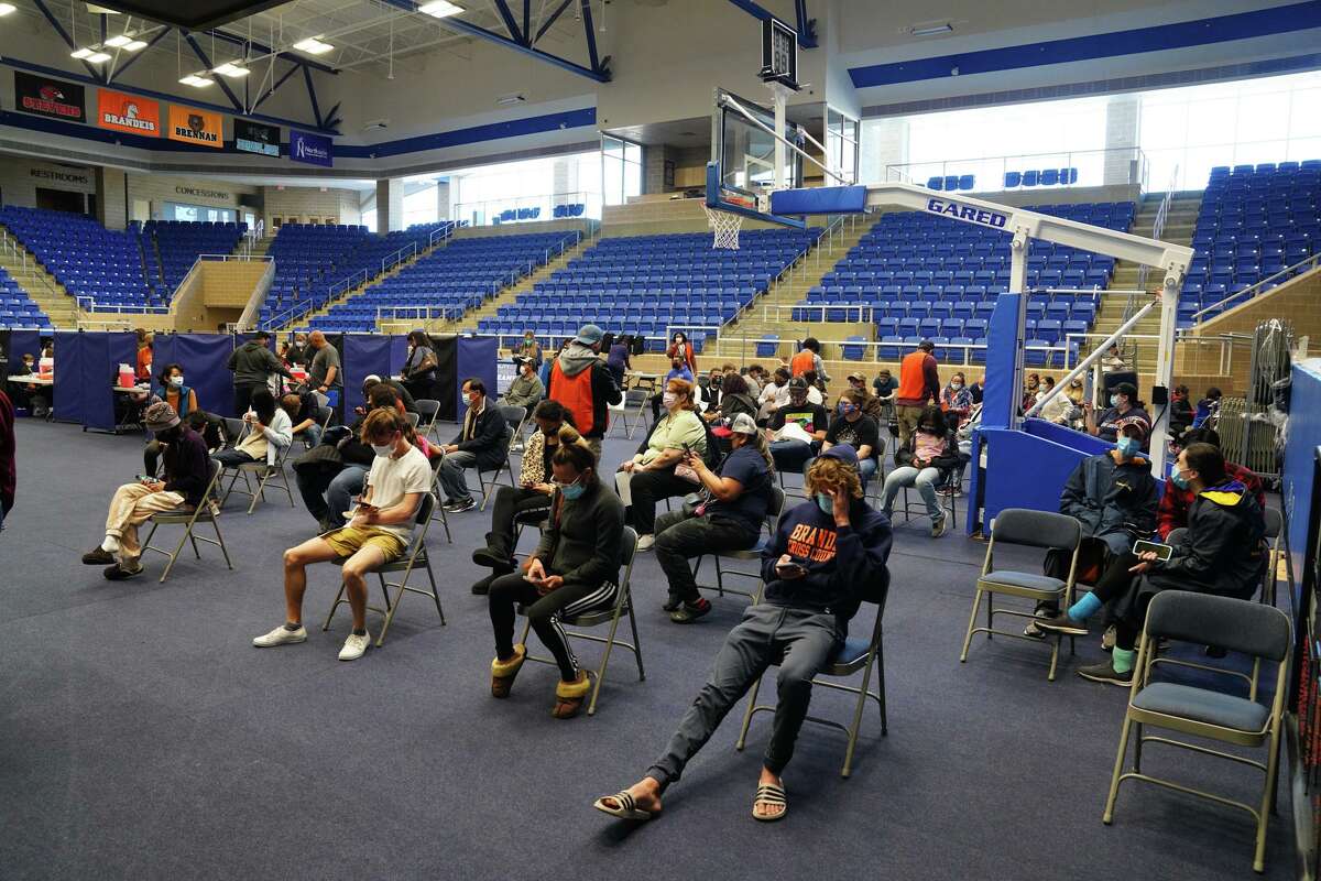 People wait to be called for their turn during a pop-up vaccination clinic at the Farris Athletic Complex Northside Sports Gym Sunday and conducted by Metro Health.