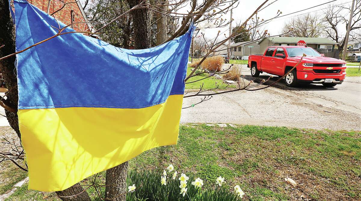 John Badman|The Telegraph A resident hung a home-made Ukrainian flag Monday on a tree in their yard at the corner of East Delmar Avenue and Curvey Street in Godfrey to show support for the Ukrainian people in the Russian invasion of their country. President Biden has accused Russia of war crimes following the discovery of what the Ukrainians say are hundreds of dead civilians recently found in a suburb of Kyiv, Ukraine. The war is now almost six weeks old.