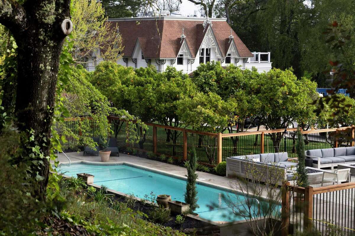 The Carriage House and pool are seen through layers of greenery at The Madrona in Healdsburg, Calif. Tuesday, March 29, 2022.