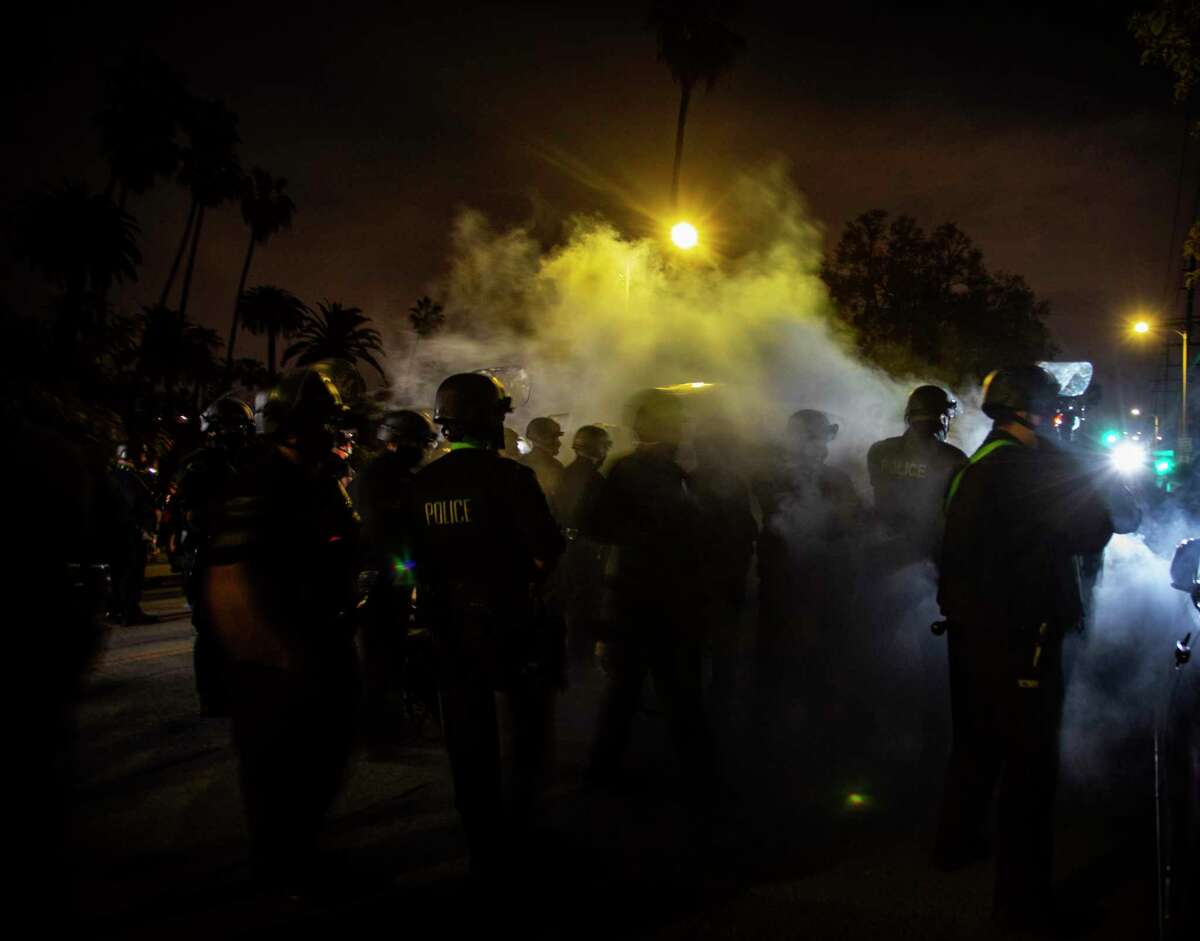 Police clash with protesters over the clearing of a homeless encampment from Echo Park Lake last year in Los Angeles.