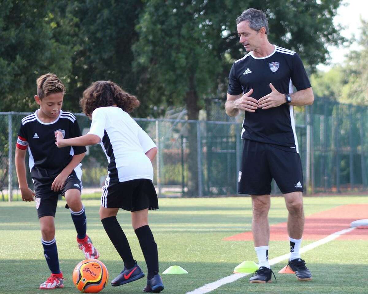 Coach Paul Decle works with students Oliver Costas and Yahya Hussein at Nexus Futbol Academy, a program combining academics and soccer for elementary school-age boys in grades 4-8. Formed in 2021 by Ibrahim Firat and Henry Costas, the school plans a move to Pearland next year.