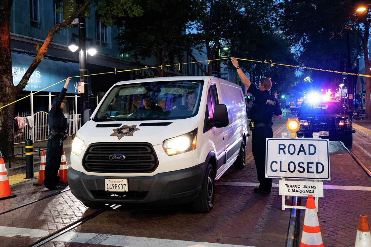 A coroner’s van pulls away from the crime scene of a mass shooting in downtown Sacramento, where six people were killed and over a dozen were wounded on April, 3, 2022.