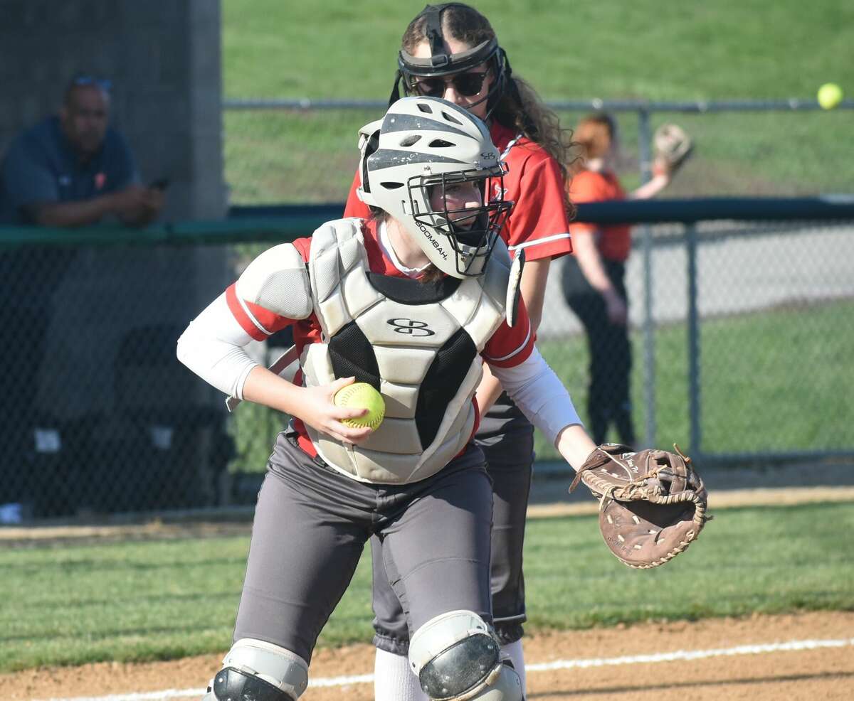 Alton catcher Audrey Evola looks back a runner after fielding a bunt against the Edwardsville Tigers on Monday in Southwestern Conference action in Godfrey.