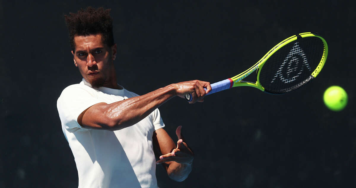 Michael Mmoh of the United States plays a forehand in his Men's Singles match against Jiri Lehecka of the Czech Republic during day one of 2022 Australian Open Qualifying at Melbourne Park on January 10, 2022 in Melbourne, Australia. (Photo by Mike Owen/Getty Images)