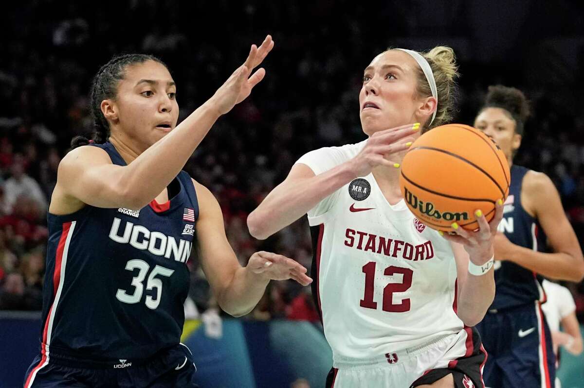 Stanford's Lexie Hull tries to get past UConn's Azzi Fudd during the first half of a college basketball game in the semifinal round of the Women's Final Four NCAA tournament Friday, April 1, 2022, in Minneapolis. (AP Photo/Eric Gay)