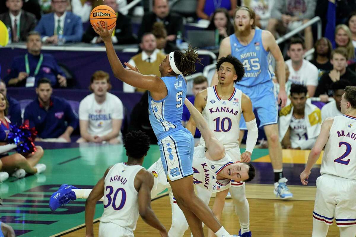 North Carolina forward Armando Bacot (5) shoots against Kansas forward Mitch Lightfoot during the first half of a college basketball game in the finals of the Men's Final Four NCAA tournament, Monday, April 4, 2022, in New Orleans.