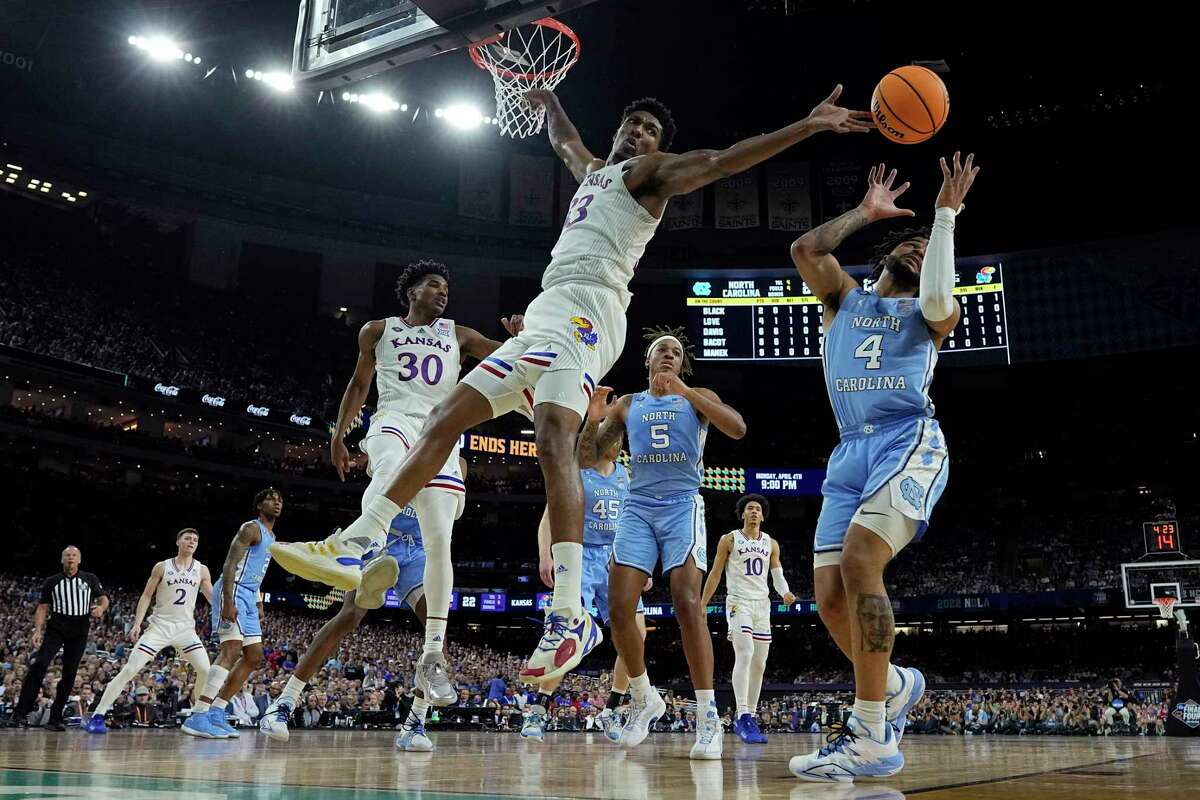 Kansas forward David McCormack vies for a loose ball with North Carolina guard R.J. Davis during the first half of a college basketball game in the finals of the Men's Final Four NCAA tournament, Monday, April 4, 2022, in New Orleans.