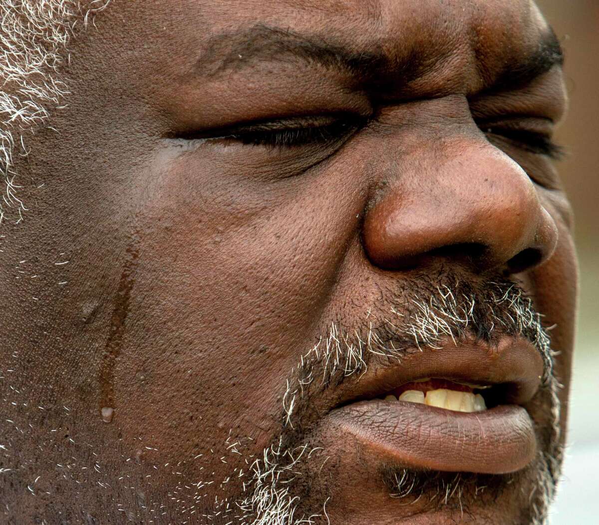 A tear rolls down Darrell Boyce’s cheek on Monday, April 4, 2022, as he talks to about 100 people who gathered at Phillis Wheatley Park to remember his son, Avante Boyce, 19, who was fatally shot near the park on March 31. Darrell Boyce is a prominent East Side anti-violence advocate.