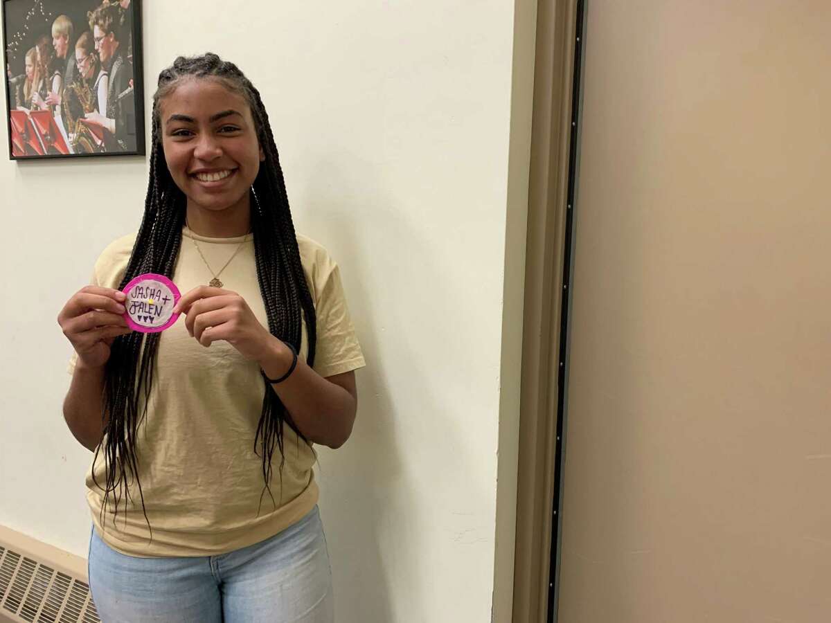 Conard High School student Sasha Belabe holds a badge she made during the Sisters in STEM program.