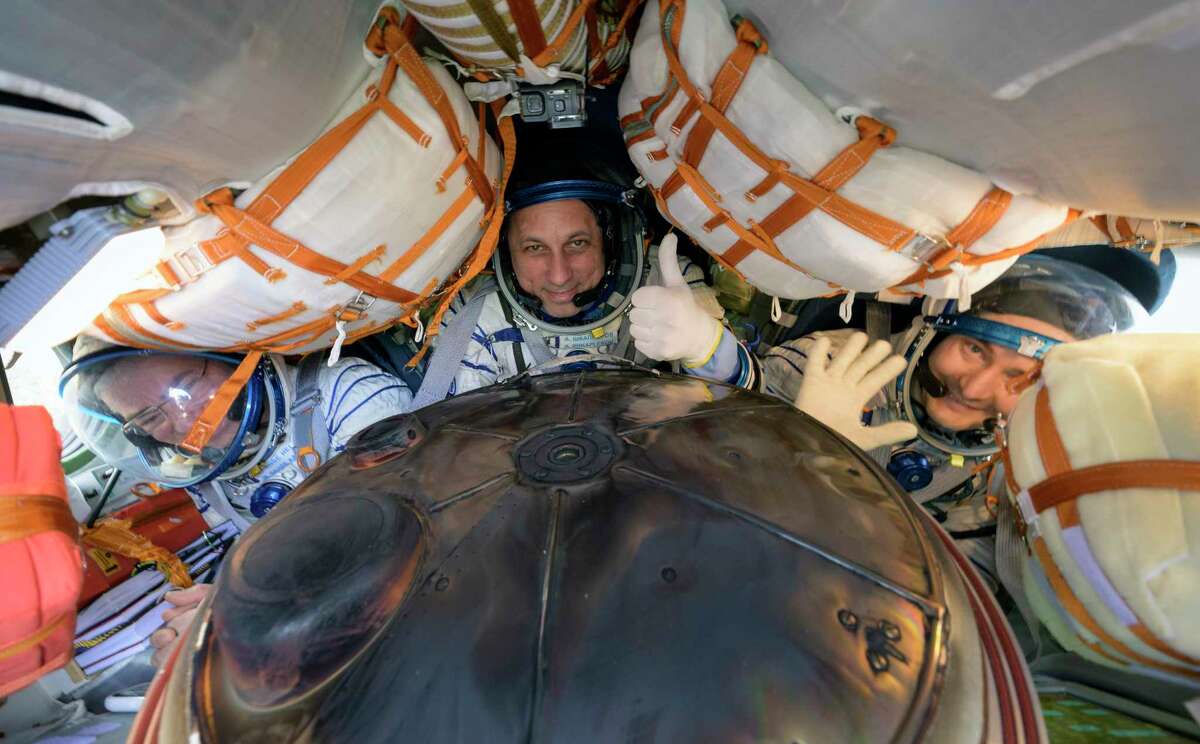 A photo provided by NASA shows, from left, Mark Vande Hei of NASA and Anton Shkaplerov and Pyotr Dubrov of Roscosmos inside a Soyuz spacecraft after landing in Kazakhstan on Wednesday, March 30, 2022. (NASA via The New York Times)