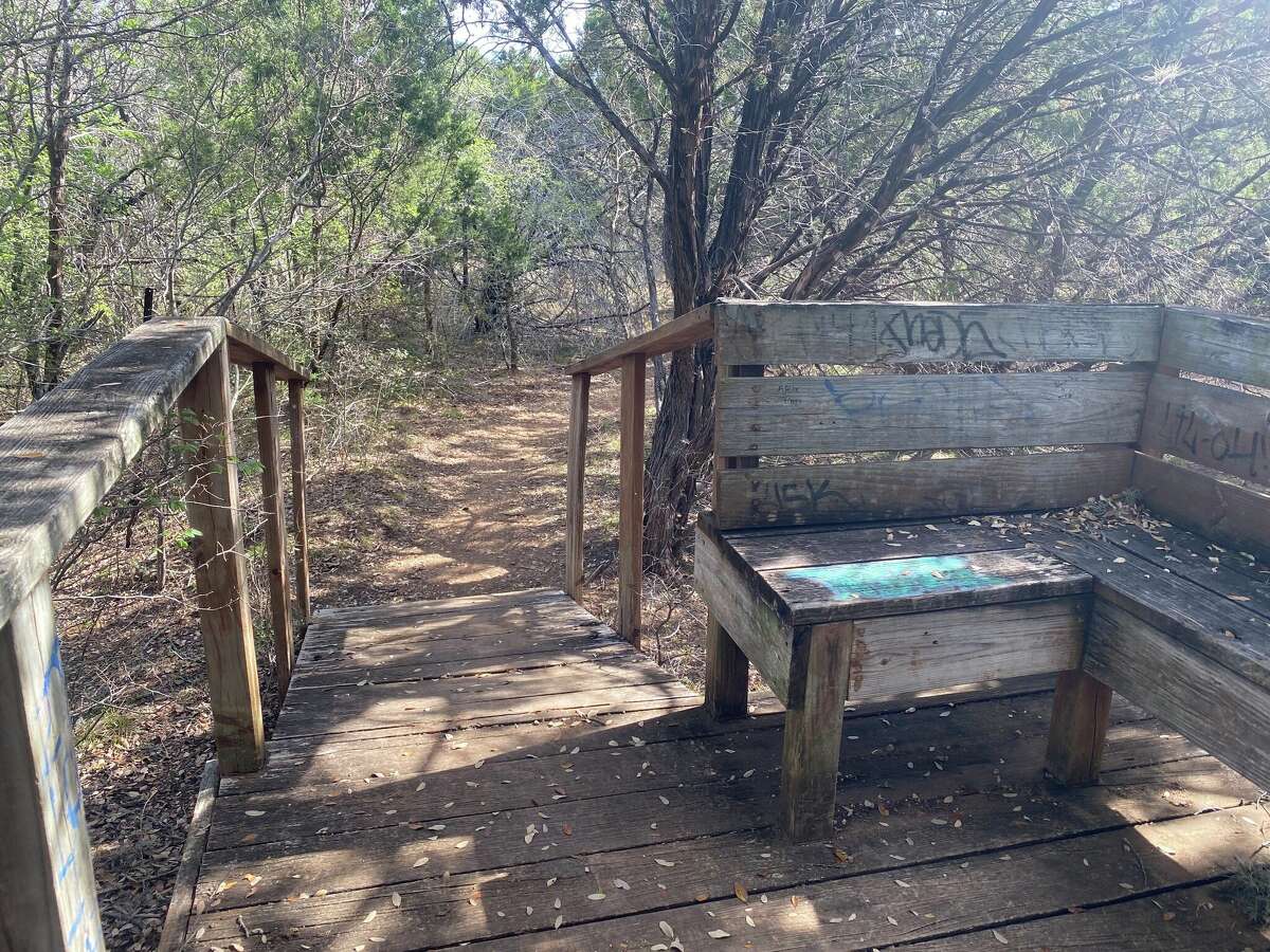 In the park, I found a bridge with a bench that had a bunch of graffiti on it. 
