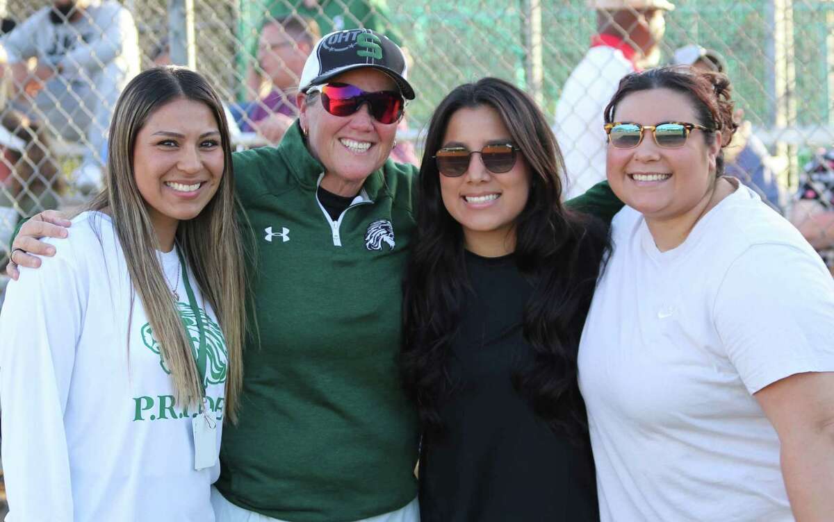 Former Spring High softball players Elyssa Hernandez, left, Dalilah Bravo, second to right, and Caitlyn Garcipose, right, celebrate with head coach Julie Wyrick.