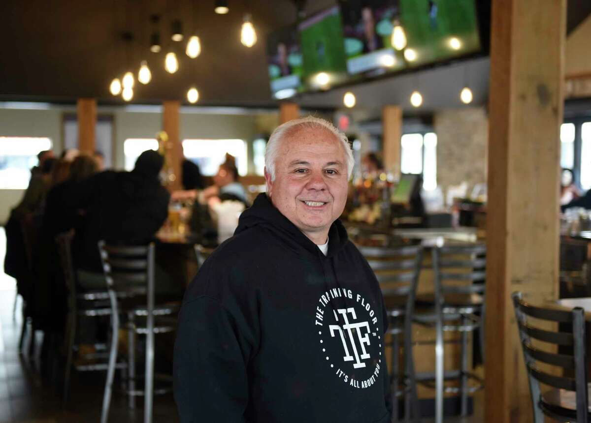 Owner Rico Imbrogno poses during opening day of Riko's Pizza in Stamford, Conn., Tuesday, April 5, 2022. Riko's Pizza opened a new location at 2010 West Main St. in Stamford on Tuesday.  The menu offers a variety of thin crust pizzas, including the famous hot oil pizza, as well as salad pizzas, hot wings and a full bar with an innovative cocktail menu.