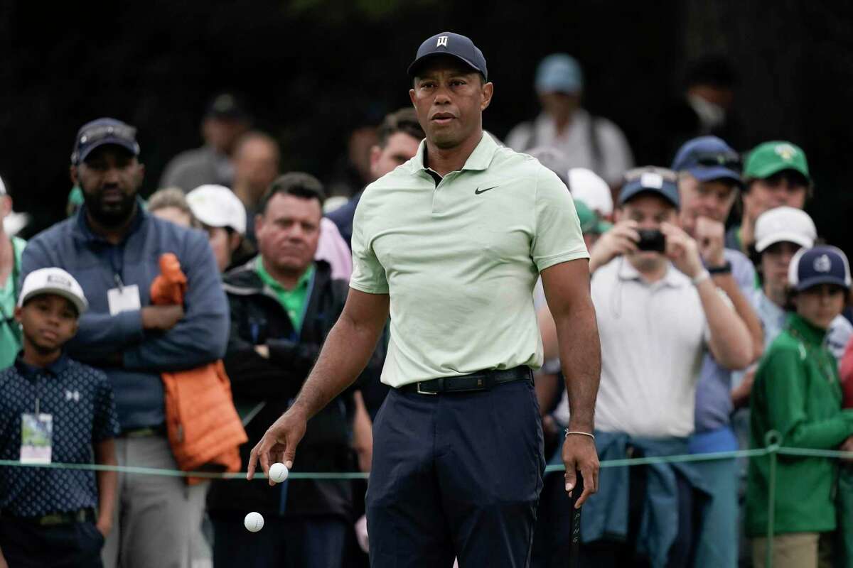 Tiger Woods drops golf balls on the driving range during a practice round for the Masters golf tournament on Tuesday, April 5, 2022, in Augusta, Ga. (AP Photo/Charlie Riedel)