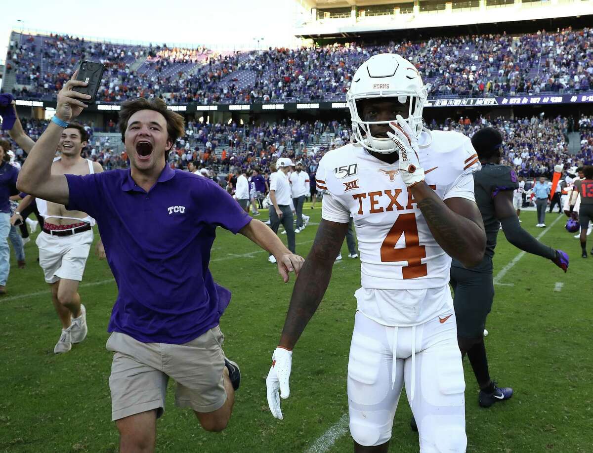 Anthony Cook (4) of the Texas Longhorns walks off as fans rush onto the field after the TCU Horned Frogs defeated the Longhorns 37-27 at Amon G. Carter Stadium on October 26, 2019 in Fort Worth.
