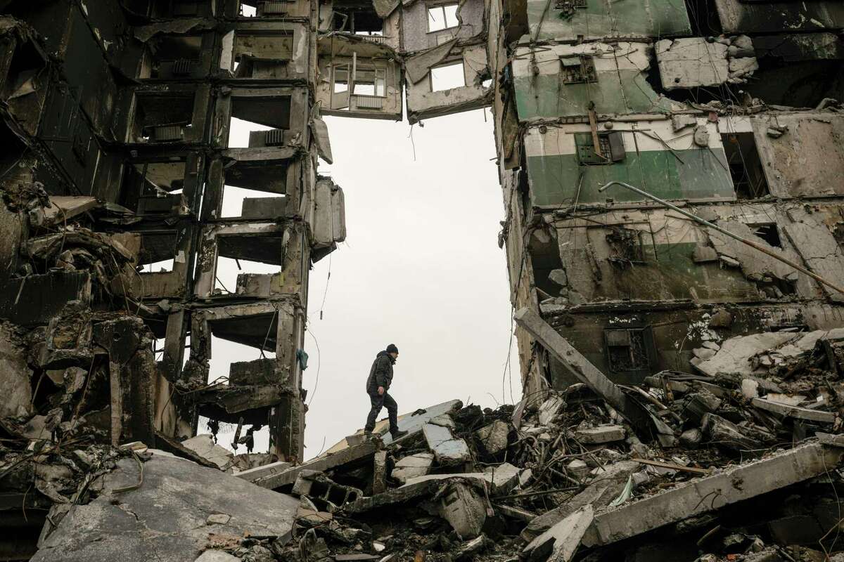 A resident looks for belongings in an apartment building destroyed during fighting between Ukrainian and Russian forces in Borodyanka, Ukraine, Tuesday, April 5, 2022.