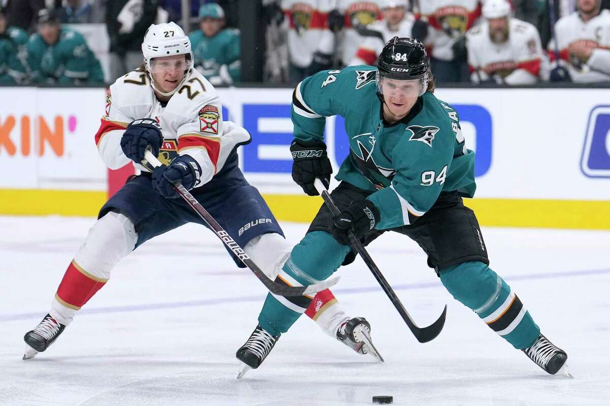San Jose Sharks left wing Alexander Barabanov (94) moves the puck up the ice past Florida Panthers center Eetu Luostarinen (27) during the first period of an NHL hockey game in San Jose, Calif., Tuesday, March 15, 2022. (AP Photo/Tony Avelar)