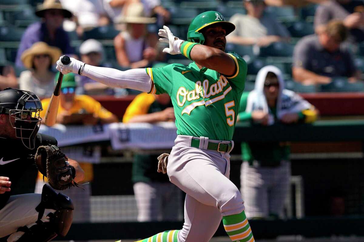 Oakland Athletics second baseman Tony Kemp (5) hits against the San Francisco Giants during the second inning of a spring training baseball game, Tuesday, April 5, 2022, in Scottsdale, Ariz. (AP Photo/Matt York)