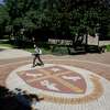 A student walks through campus Tuesday, Sept. 29 2020, at the University of St. Thomas in Houston.
