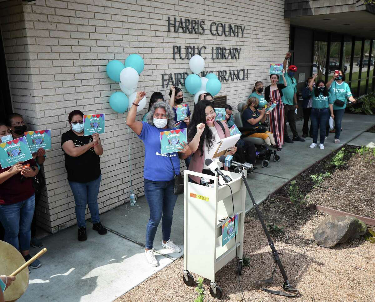 Maria Hernandez, center-left, and translator Naiyolis Palomo celebrate the launch of the Harris County Public Library system’s new enhanced library cards during a press conference Tuesday, April 5, 2022, at the Harris County Public Library Fairbanks Branch in Houston.