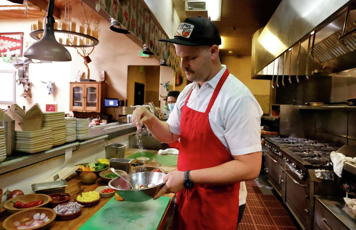 August Schuchman, executive chef West of Pecos, sprinkles salt as he prepares the plant-based cerviche, using vegan tuna from Current Foods.