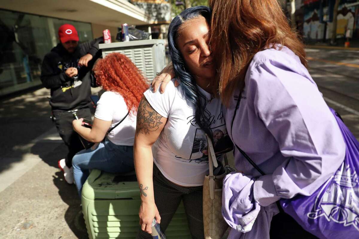 In the aftermath of last weekend’s mass shooting that killed 6 people, Tamika Young, sister of victim Devazia Turner, is consoled by Eileen Verras at the scene of her brother’s death at 10th and K in Sacramento, Calif., on Tuesday, April 5, 2022.