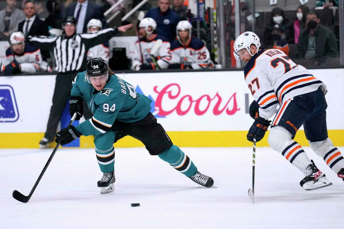 San Jose Sharks left wing Alexander Barabanov (94) chases the puck as Edmonton Oilers defenseman Brett Kulak (27) defends during the first period of an NHL hockey game Tuesday, April 5, 2022, in San Jose, Calif. (AP Photo/Tony Avelar)