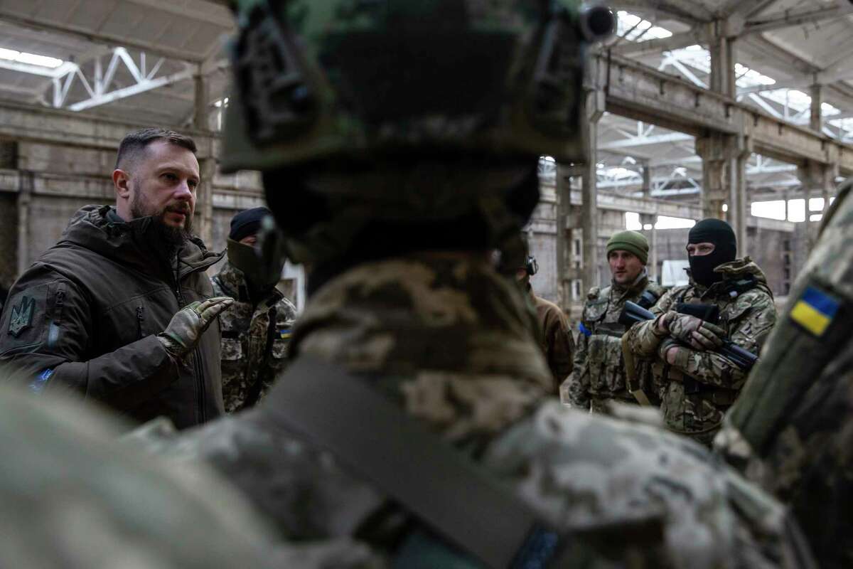 The Azov force's founder and top commander, Col. Andriy Biletskiy, left, speaks to fighters at a training site in Kyiv, Ukraine, on March 24.