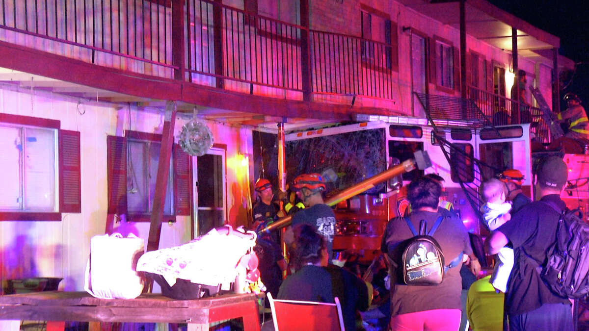 A San Antonio fire truck was totaled and more than a dozen people were displaced after a sedan crashed into the truck, causing it to hit a nearby apartment complex near Hillcrest and Quill drives. 