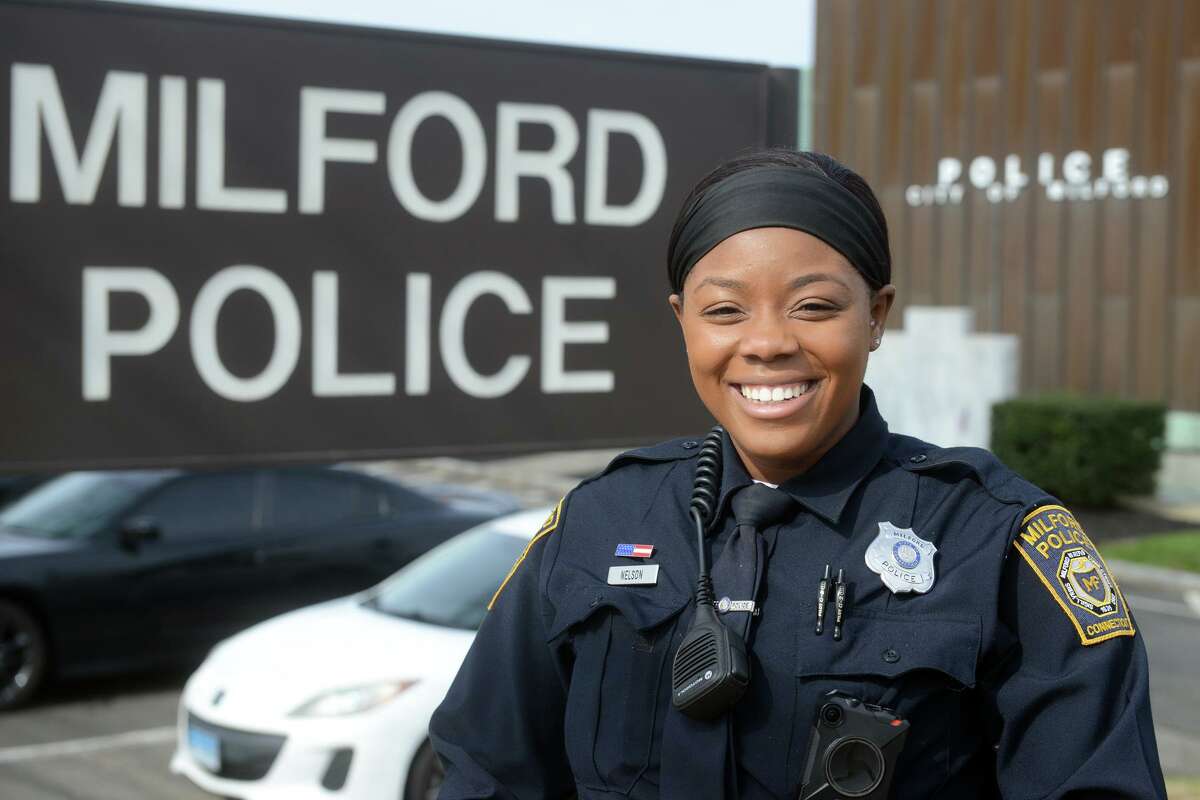 Milford Police Officer Patricia Nelson poses in front of department headquarters in Milford, Conn. April 5, 2022.