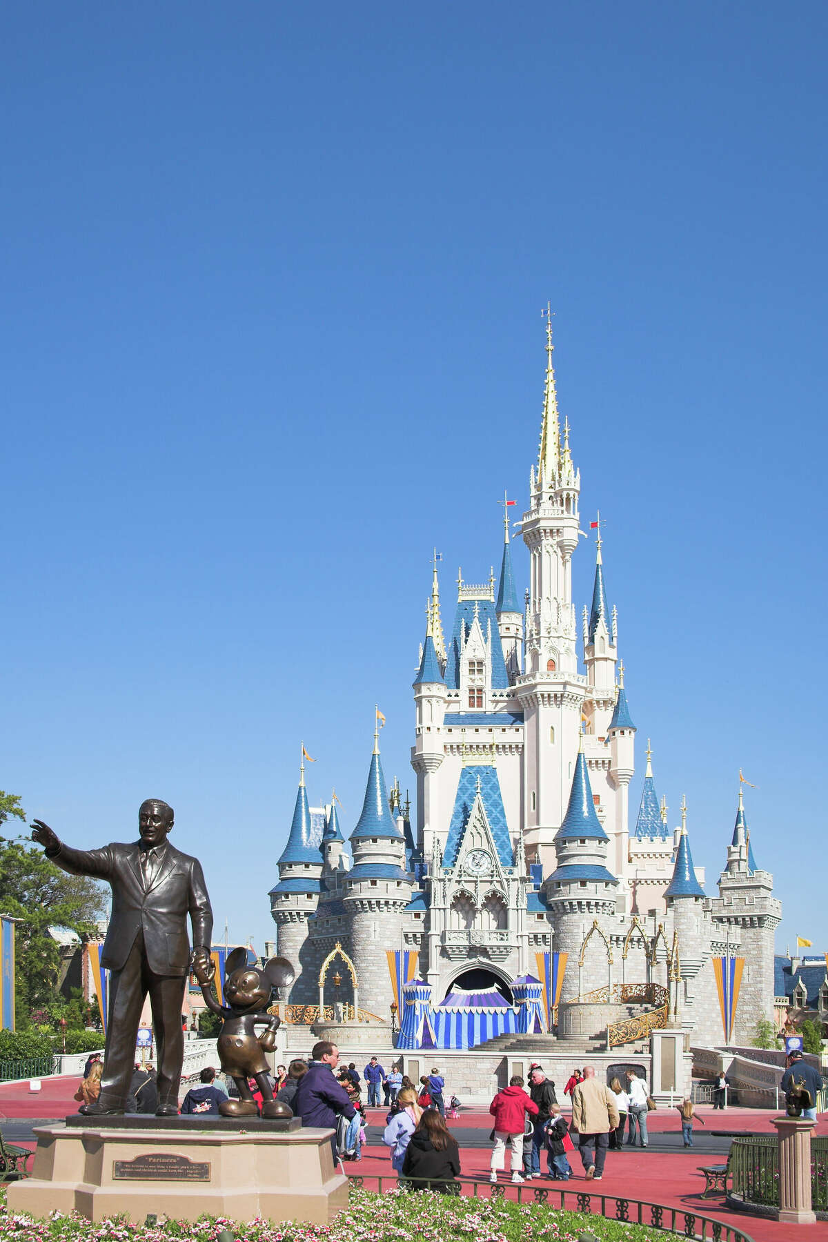 Walt Disney and Mickey Mouse Partners statue and Cinderella Castle, Magic Kingdom, Orlando, Florida, USA