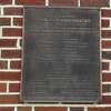 New Canaan Police Department plaque showing history of the building.