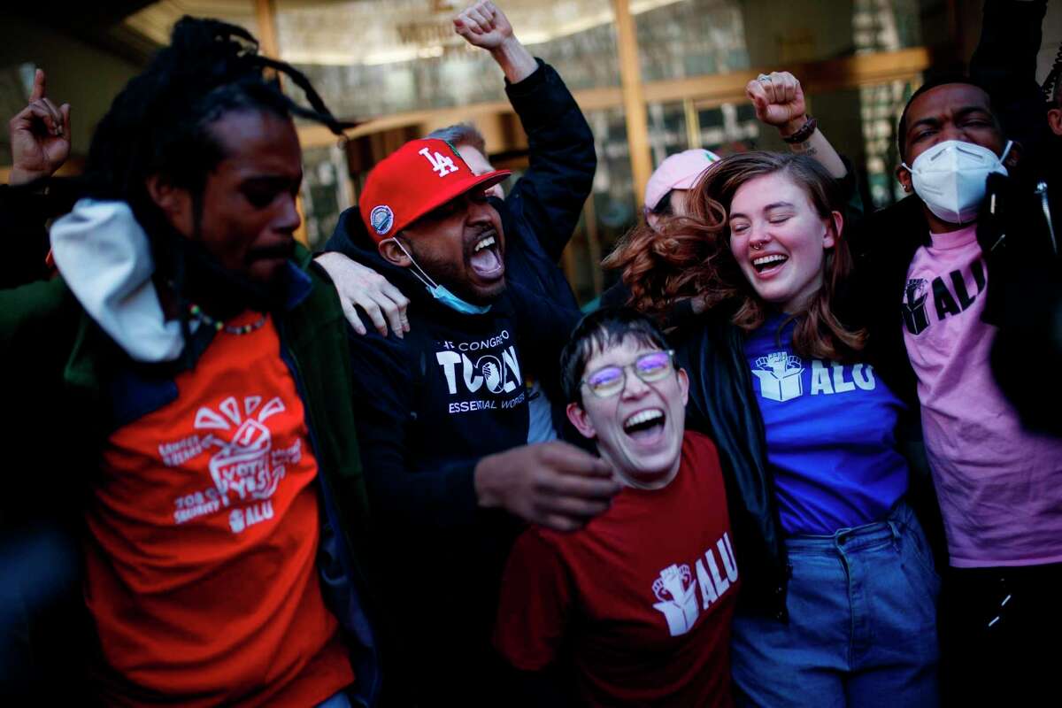Workers at the Amazon distribution center on Staten Island, N.Y., celebrate after voting to unionize on Friday. The unionization is the first successful U.S. organizing effort in the retail giant’s history.