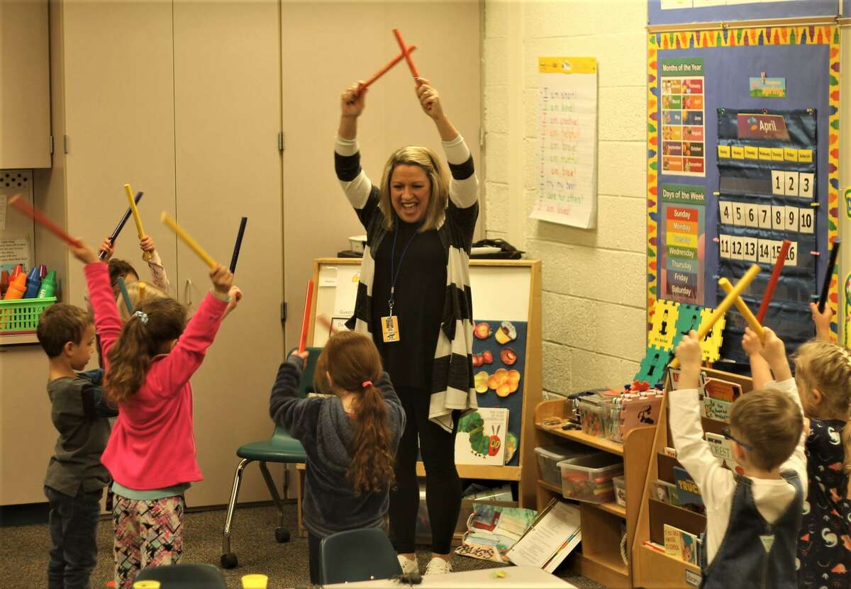 In this file photo, Onekama Consolidated Schools preschool teacher Betsy Neph leads her students in singing and dancing to the song, "Music Music." The Onekama, Bear Lake and Kaleva Norman Dickson school districts are requesting operating millage renewals during the May 3 election.