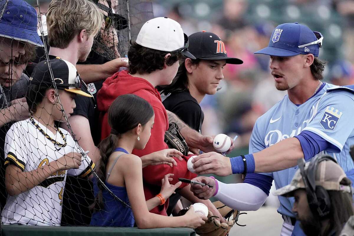 Kansas City Royals’ Bobby Witt Jr. signs autographs before a spring training baseball game in Surprise, Ariz. last month. A new season offers renewed hope.