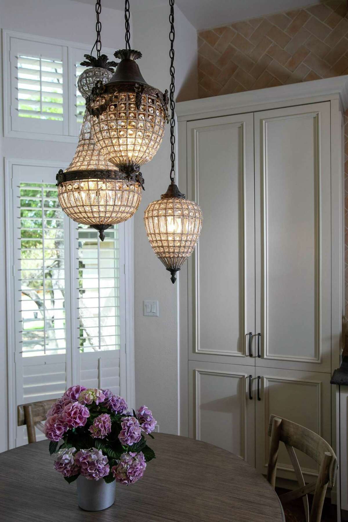 Over the table i the dining nook hang a trio of rebuilt and rewired antique crystal pendants from Egypt. .
