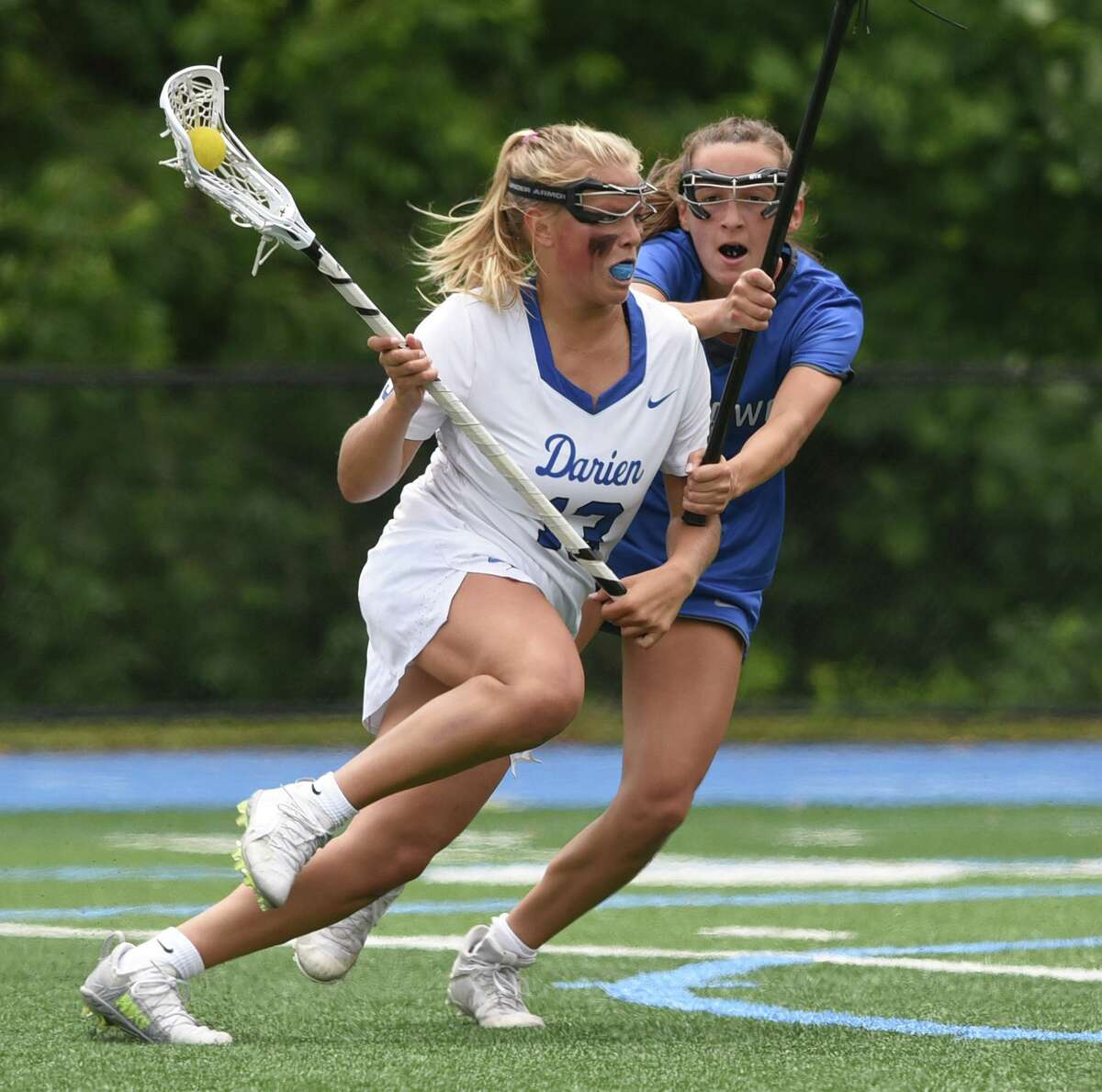 Darien's Molly McGuckin, wearing No. 13 as a junior, looks for a shot while Ludlowe's Claire Davenport (10) defends during the 2021 CIAC Class L girls lacrosse final.