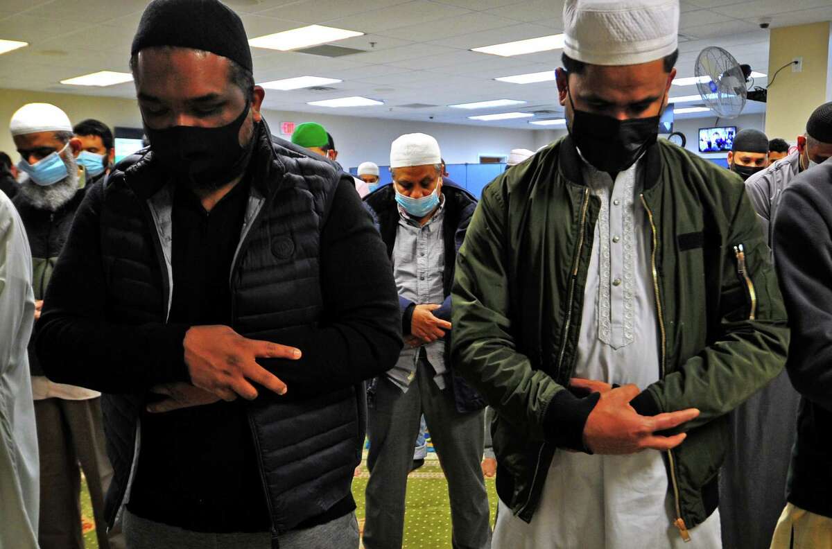Area Muslims join together for evening prayer during Ramadan at Stamford Islamic Center on Tuesday. Ramadan is the ninth month of the Islamic calendar, and observed by Muslims worldwide as a month of fasting, prayer, reflection and community. At left, Imam Hafiz Haqqani M. Qadri leads prayer.