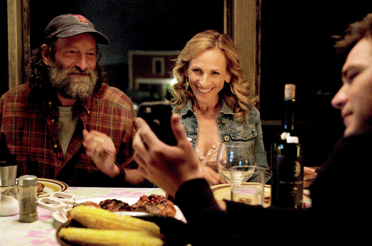 Troy Kotsur (left) and Marlee Matlin share a scene in the Academy Award-winning "CODA." 