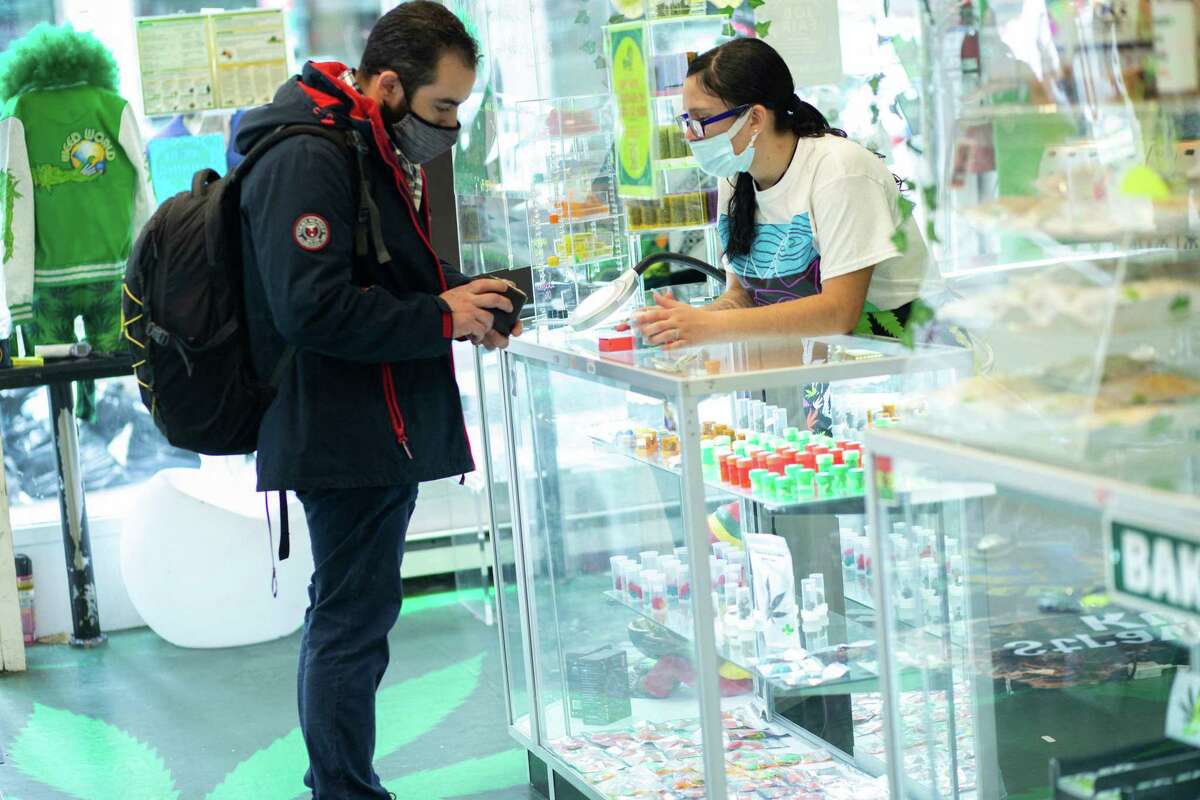 A customer from Connecticut buys marijuana supplies at the Weed World store on March 31, 2021, in New York.