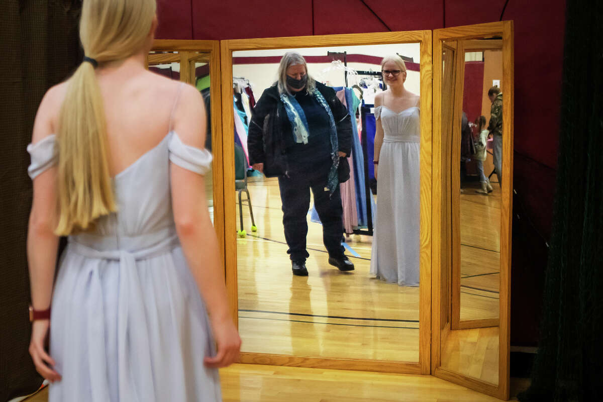 Emily Kuehne, 17, tries on a dress during the "Share Your Memories" event, which provides free formal dresses to local girls, Wednesday, April 6, 2022 at Greater Midland North Family Center.